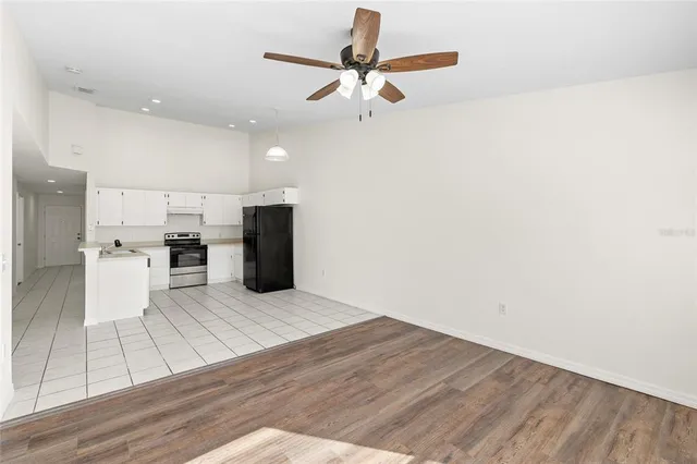 a view of kitchen with sink and refrigerator