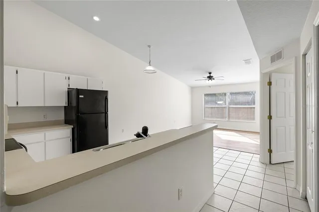 a kitchen with stainless steel appliances a refrigerator and a stove top oven