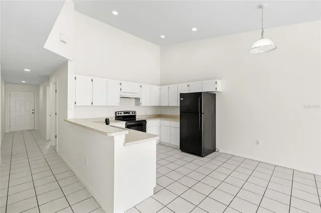 a kitchen with stainless steel appliances a refrigerator a stove a microwave and cabinets