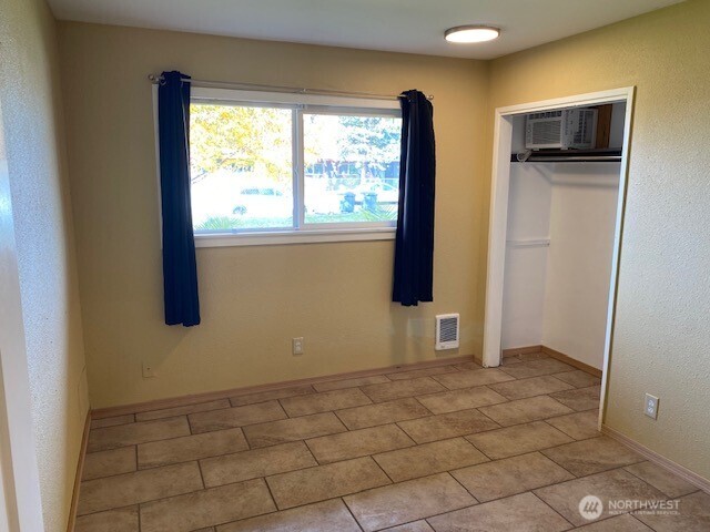 9016 Bong Loop, Unit B Moses Lake, WA 98837 - Photo 15 of 19 a view of an empty room with window and refrigerator