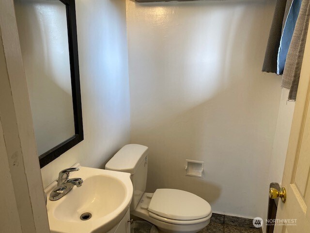 9016 Bong Loop, Unit B Moses Lake, WA 98837 - Photo 16 of 19 a white toilet sitting next to a bathroom sink