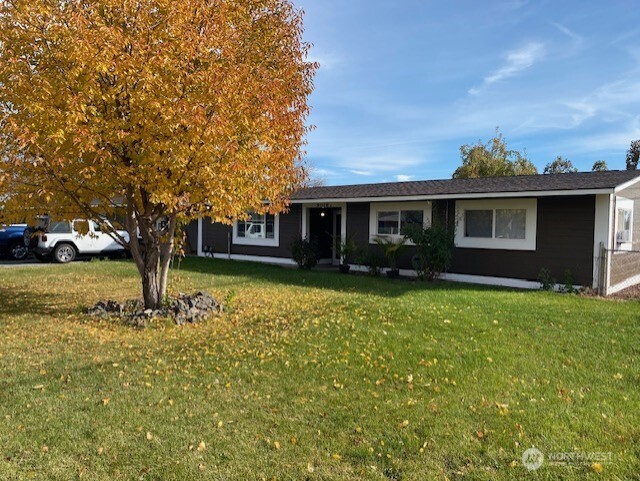 9016 Bong Loop, Unit B Moses Lake, WA 98837 - Photo 3 of 19 a front view of a house with garden