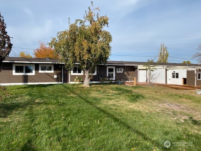 9016 Bong Loop, Unit B Moses Lake, WA 98837 - Photo 5 of 19 a front view of a house with a yard table and chairs