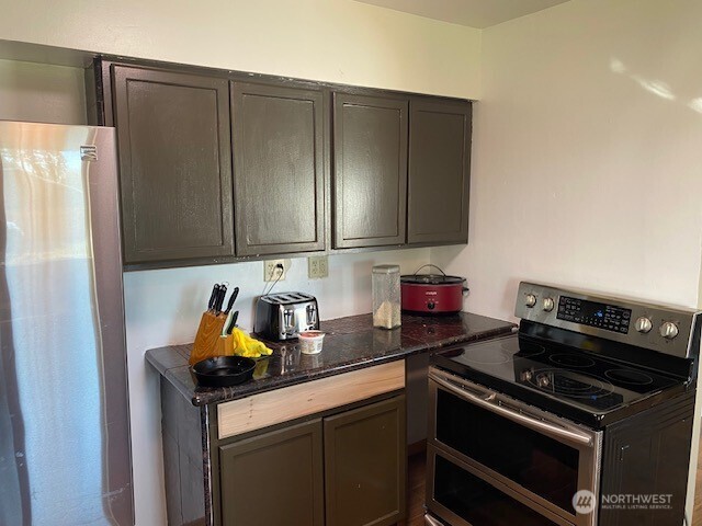 9016 Bong Loop, Unit B Moses Lake, WA 98837 - Photo 9 of 19 a kitchen with a stove and a refrigerator