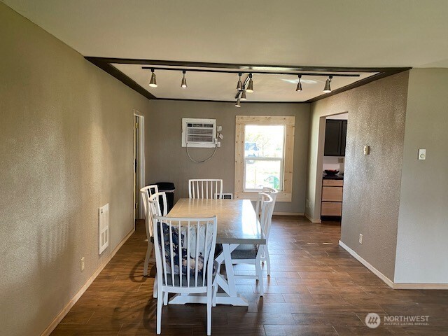 9016 Bong Loop, Unit B Moses Lake, WA 98837 - Photo 10 of 19 a view of a dining room with furniture and wooden floor