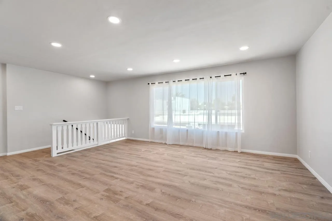 3276-3282 Main Street Lemon Grove, CA 91945 - Photo 13 of 75 a view of an empty room with wooden floor and fence