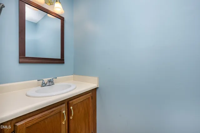 a view of a room with wooden floor and white walls