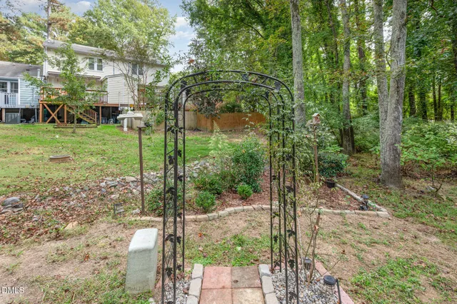 a view of a house with a yard and deck