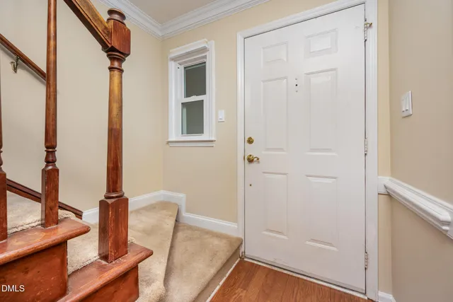 a view of a brick house with large windows and a large tree