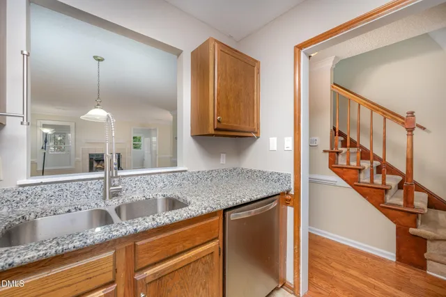 a view of a livingroom with wooden floor and a fireplace