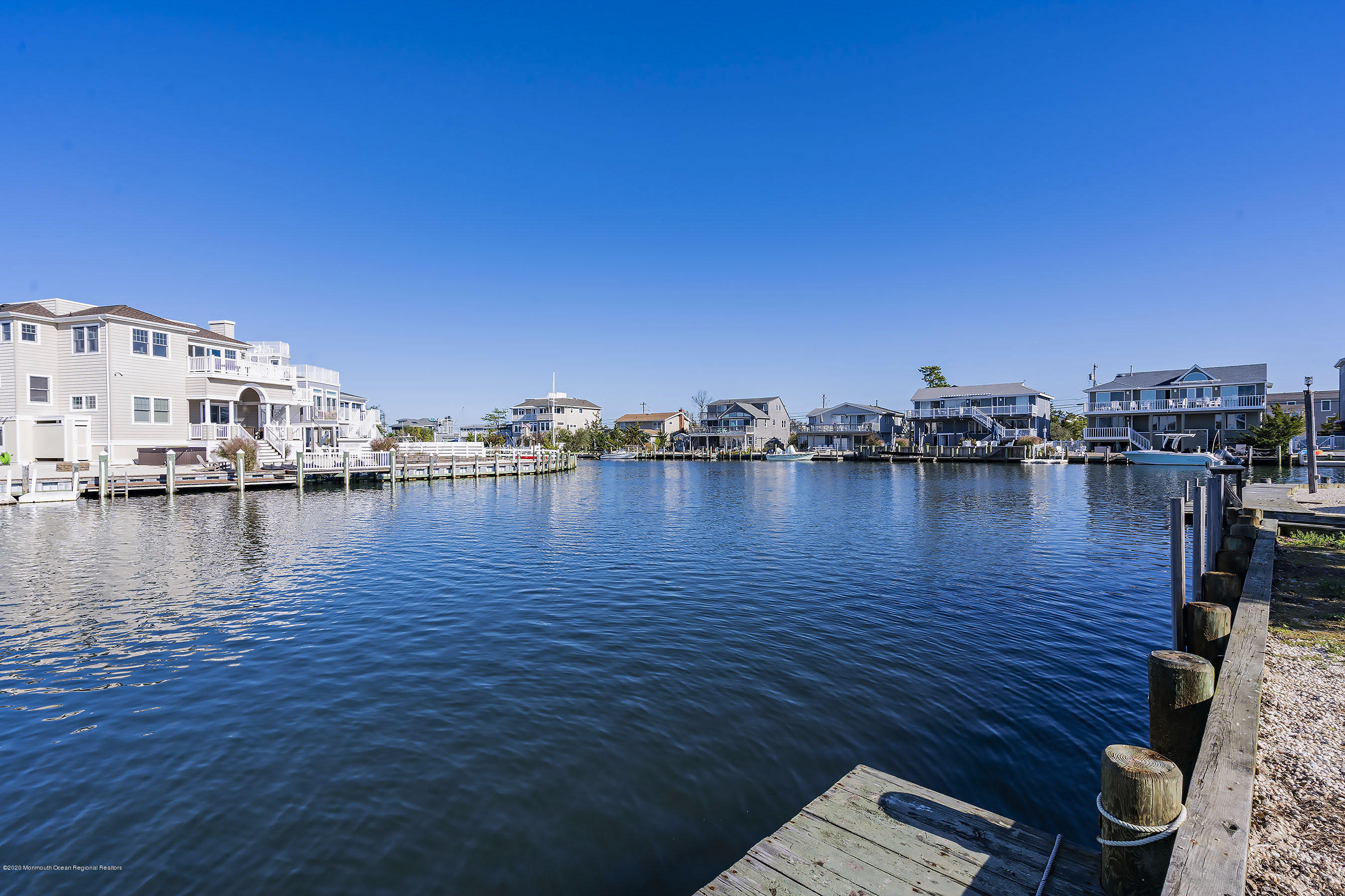 50 Amherst Road Barnegat Light, NJ 08006 - Photo 12 of 34 a view of a lake with boats and trees in the background