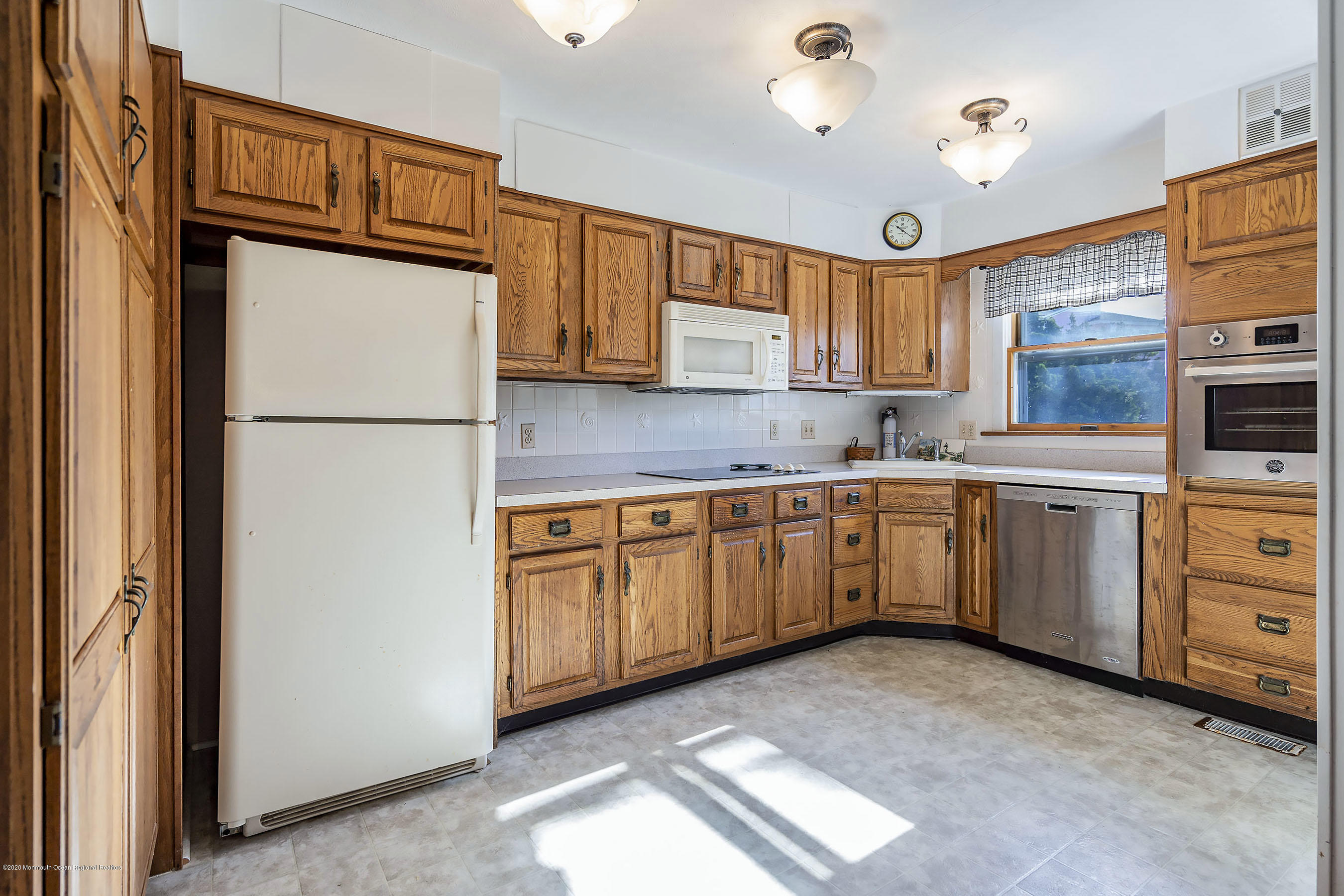 50 Amherst Road Barnegat Light, NJ 08006 - Photo 19 of 34 a kitchen with white cabinets and white appliances