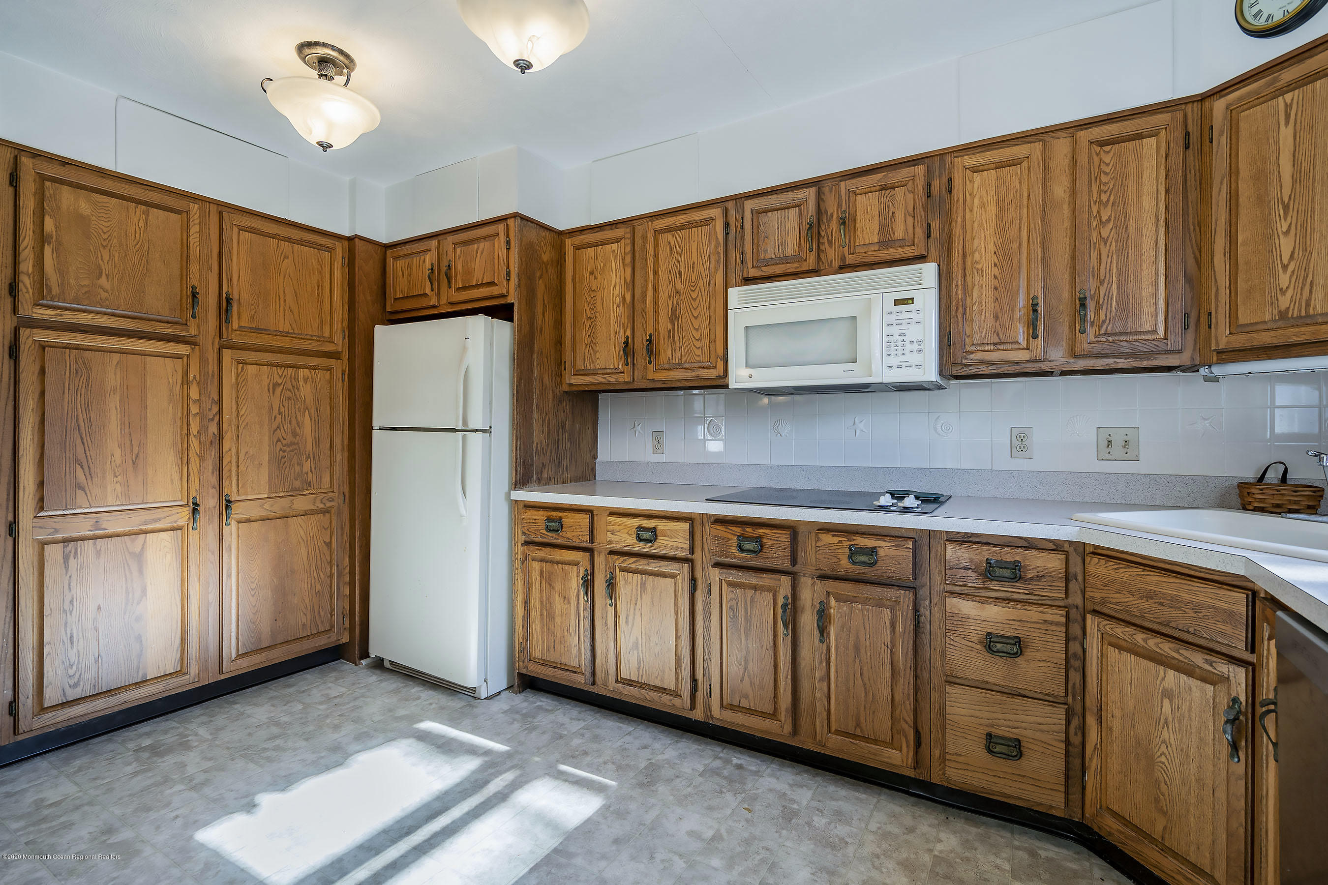 50 Amherst Road Barnegat Light, NJ 08006 - Photo 20 of 34 a kitchen with stainless steel appliances granite countertop a refrigerator sink and cabinets