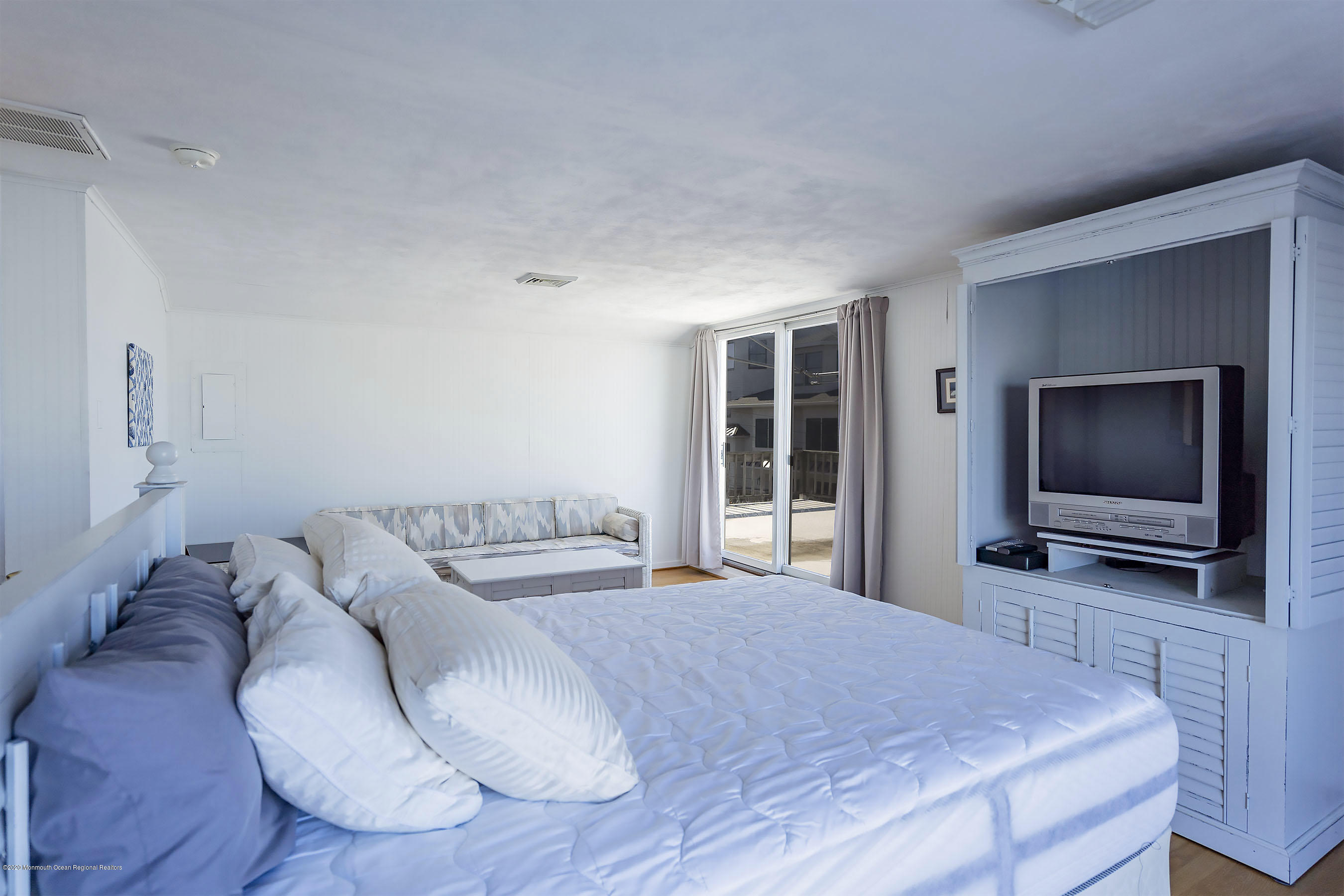 50 Amherst Road Barnegat Light, NJ 08006 - Photo 7 of 34 a bedroom with a bed and a flat screen tv