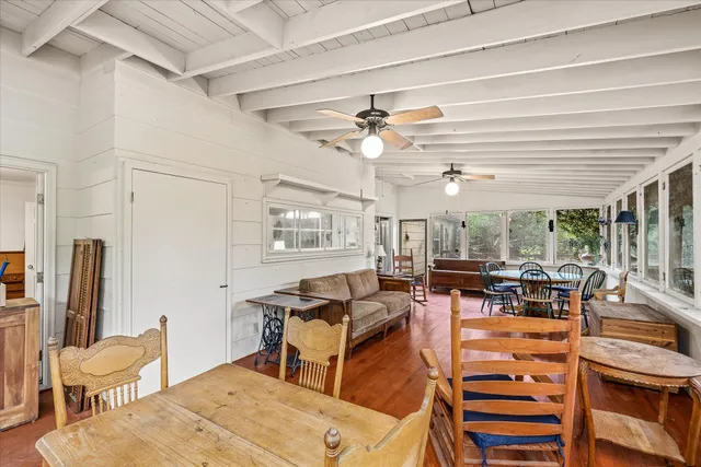 a living room with furniture a large window and stainless steel appliances
