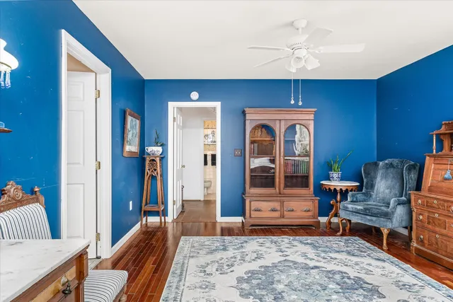 a bedroom with furniture and wooden floor