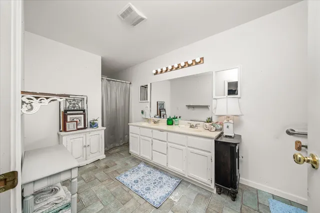 a kitchen with white cabinets and counter space