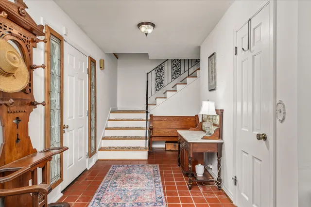 a view of a hallway with furniture and entryway