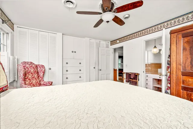 a large bedroom with a large bed and a chandelier