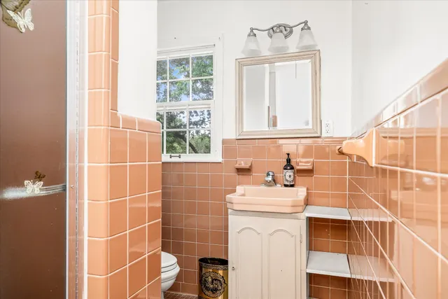 a bathroom with a sink vanity mirror and a bathtub