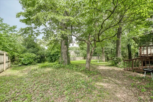 a view of a patio with chairs potted plants