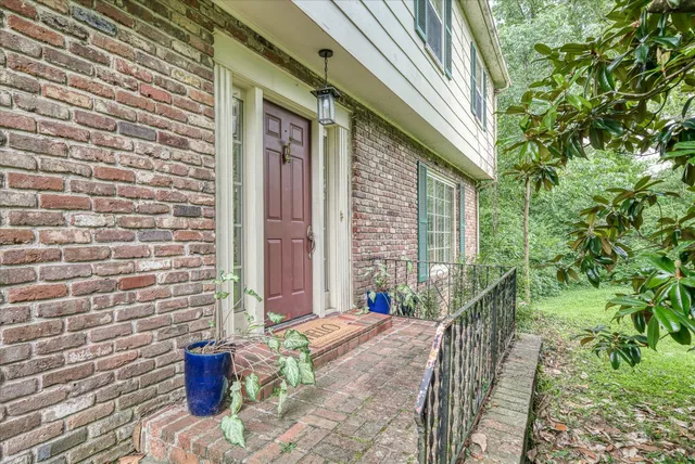 a pathway of a house with a yard