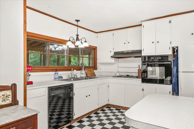 a kitchen with stainless steel appliances a sink and a stove