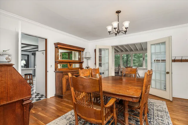 a dining room with furniture window and wooden floor
