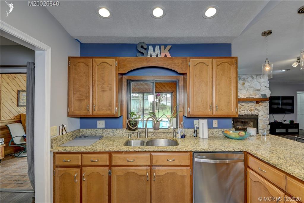 1654 Southwest 85th Terrace Stuart, FL 34997 - Photo 14 of 48 a kitchen with granite countertop a sink and a granite counter tops