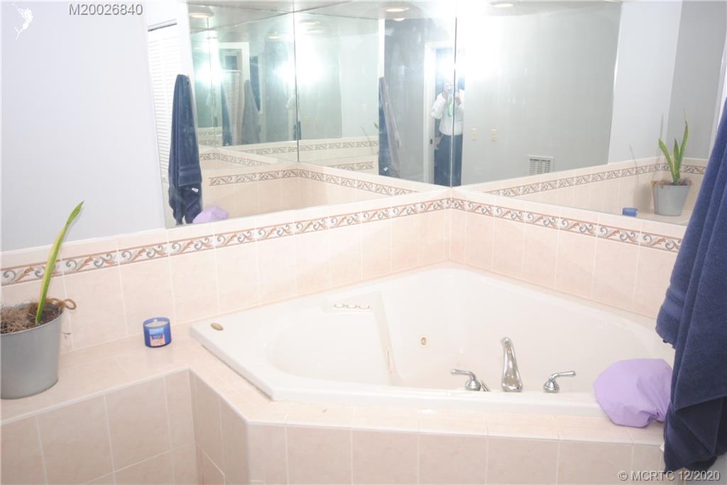 1654 Southwest 85th Terrace Stuart, FL 34997 - Photo 29 of 48 a bathroom with a tub sink and mirror