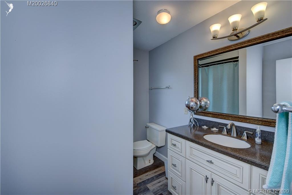 1654 Southwest 85th Terrace Stuart, FL 34997 - Photo 31 of 48 a bathroom with a granite countertop sink a toilet and a mirror