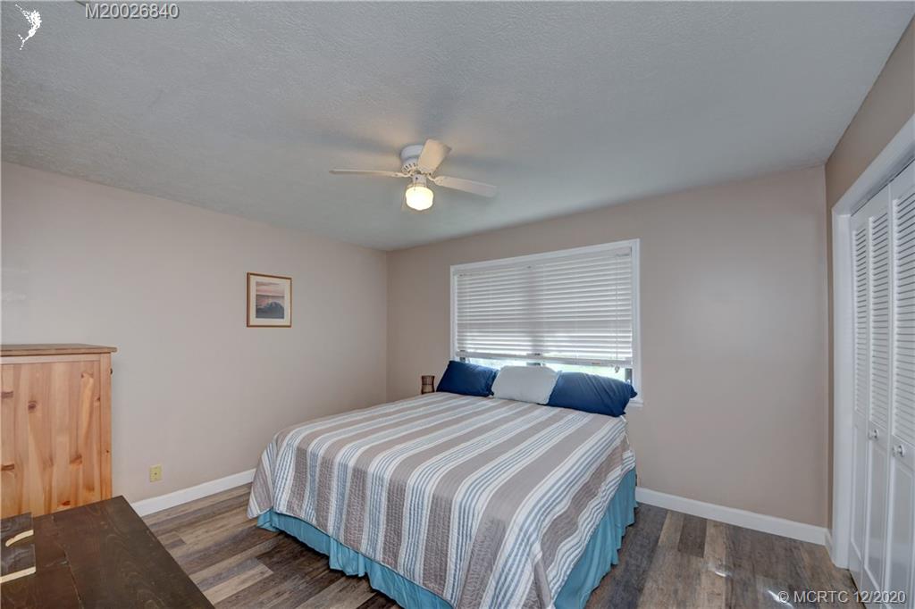 1654 Southwest 85th Terrace Stuart, FL 34997 - Photo 32 of 48 a bedroom with a bed and a window