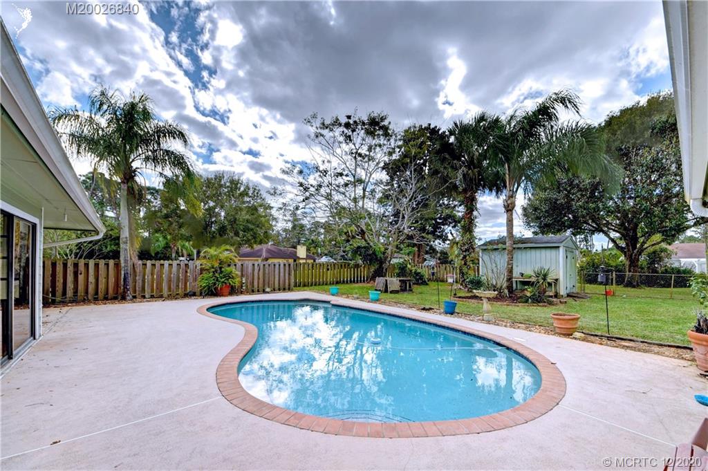 1654 Southwest 85th Terrace Stuart, FL 34997 - Photo 36 of 48 a view of a house with swimming pool and a yard