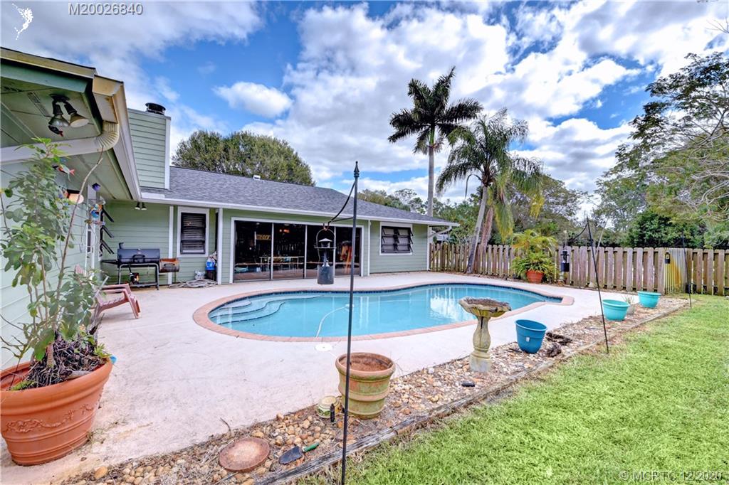 1654 Southwest 85th Terrace Stuart, FL 34997 - Photo 37 of 48 a front view of a house with swimming pool and furniture