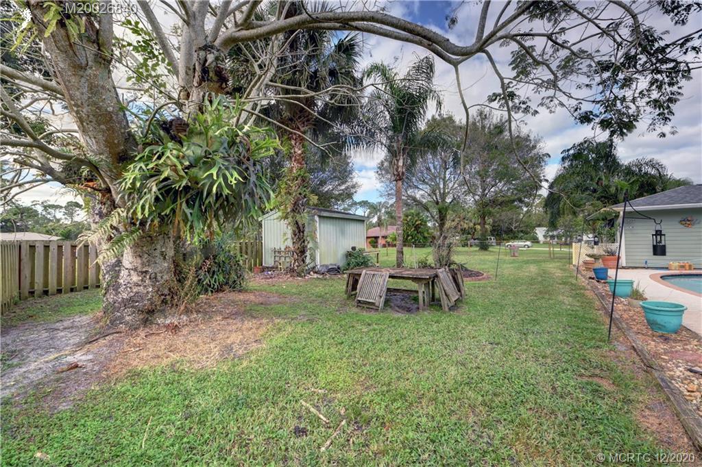 1654 Southwest 85th Terrace Stuart, FL 34997 - Photo 38 of 48 a view of a house with backyard and sitting area