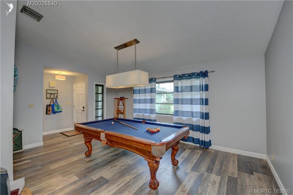 1654 Southwest 85th Terrace Stuart, FL 34997 - Photo 7 of 48 a room with pool table and windows