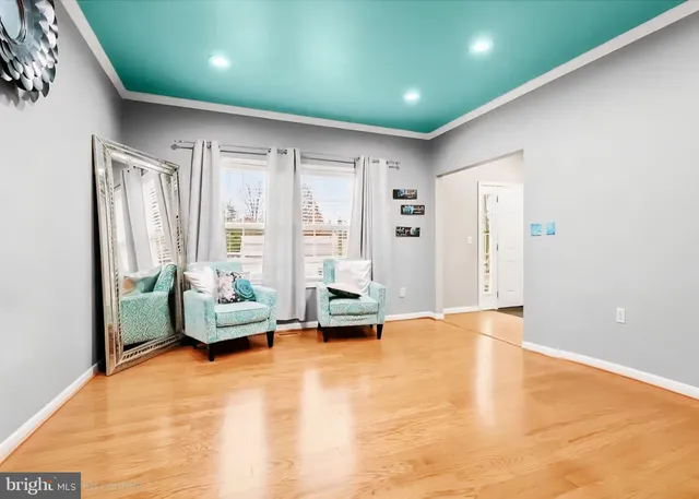 a living room with furniture window and wooden floor