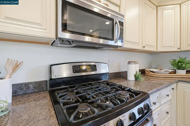 a stove top oven sitting inside of a kitchen