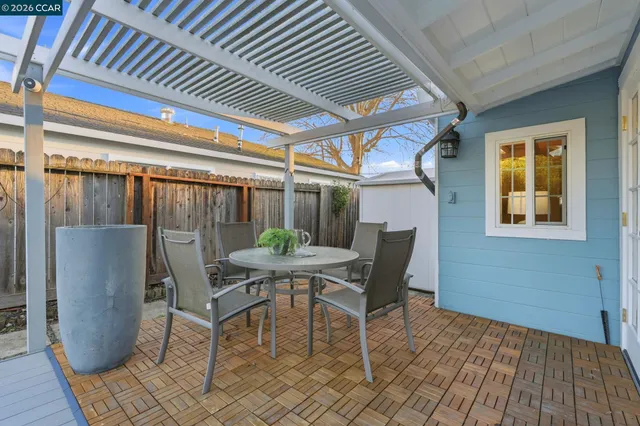a view of a house with backyard and sitting area