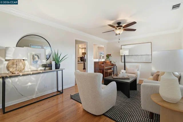 a living room with furniture a rug and a window