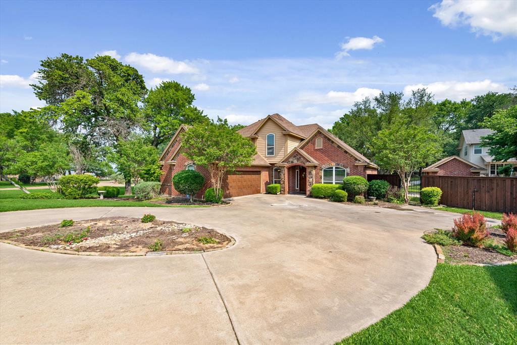 a front view of a house with a yard and trees