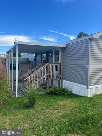 a view of a house with a yard and deck