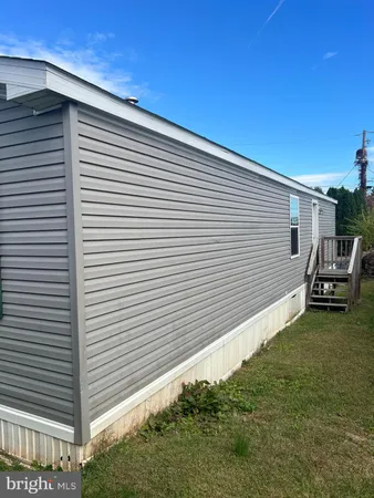 a view of a white house with a yard