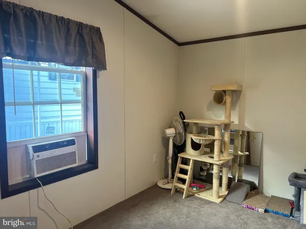a view of a room with wooden floor and windows