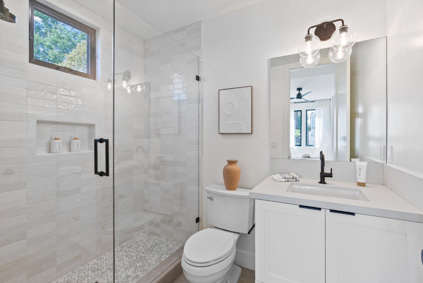 4875 Opal Street Capitola, CA 95010 - Photo 25 of 49 a bathroom with a toilet a sink a mirror and shower