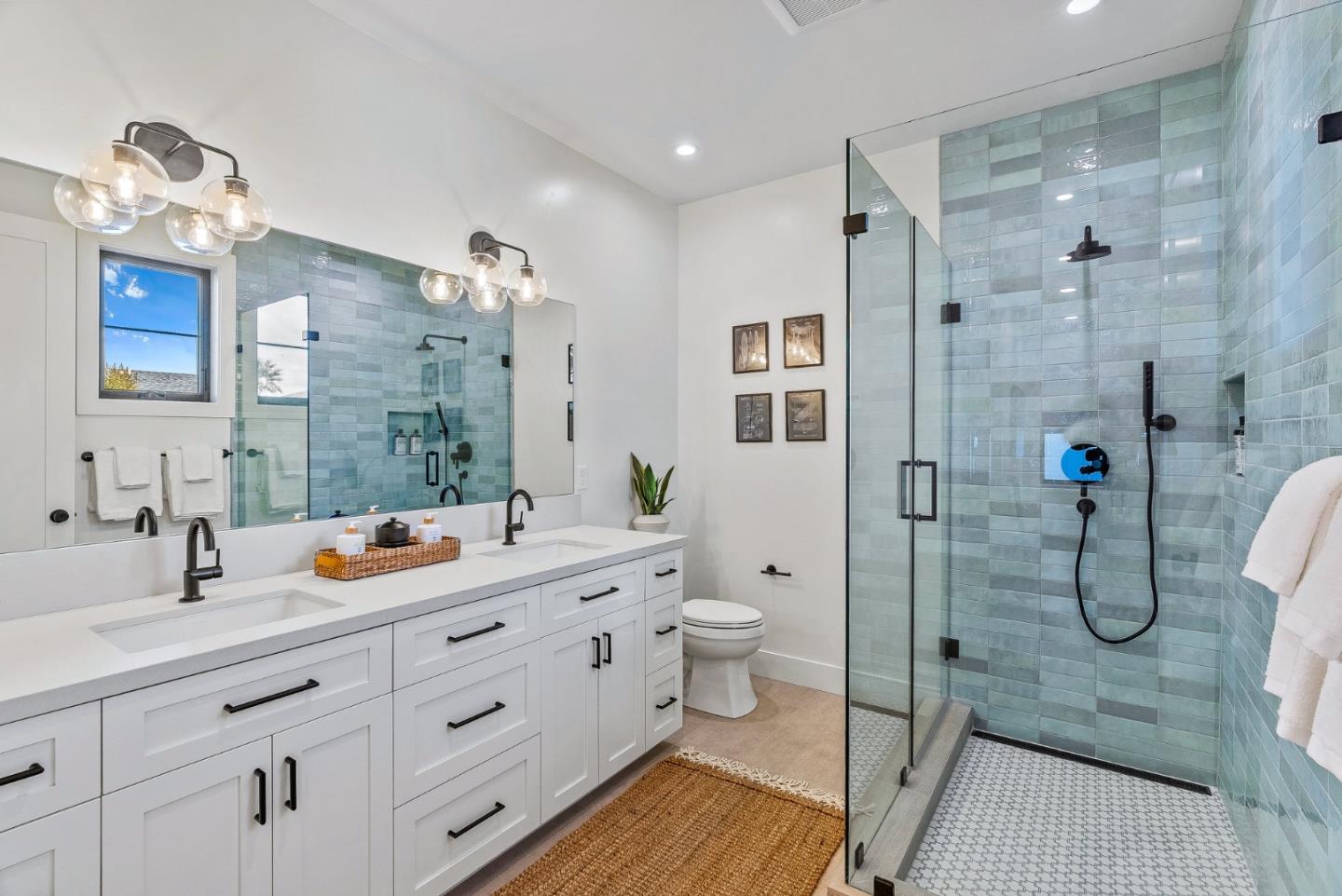 4875 Opal Street Capitola, CA 95010 - Photo 35 of 49 a spacious bathroom with a double vanity sink a toilet a shower and a mirror