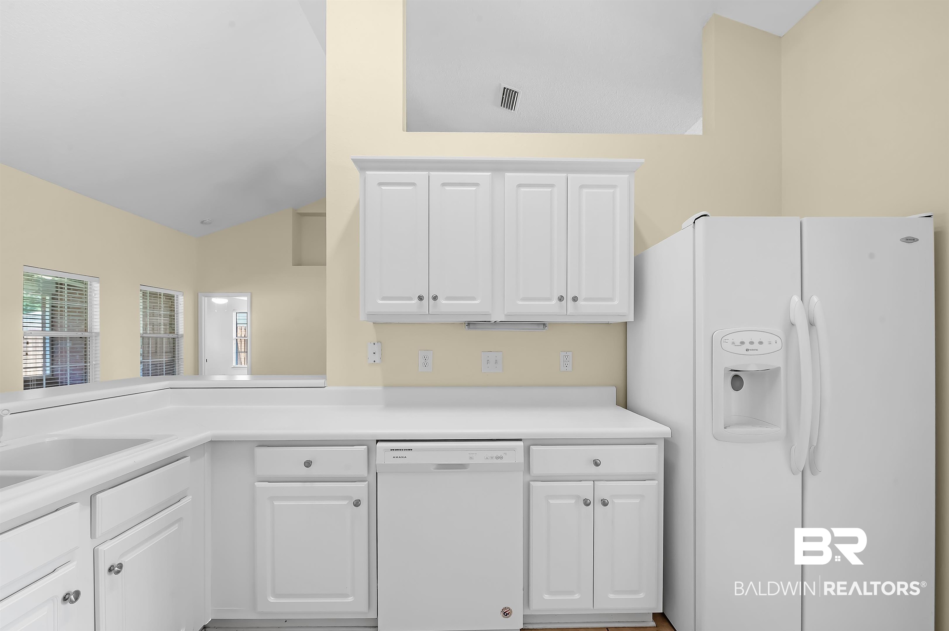 12443 Venice Boulevard Foley, AL 36535 - Photo 34 of 59 Kitchen with lofted ceiling, white cabinets, white appliances, and sink
