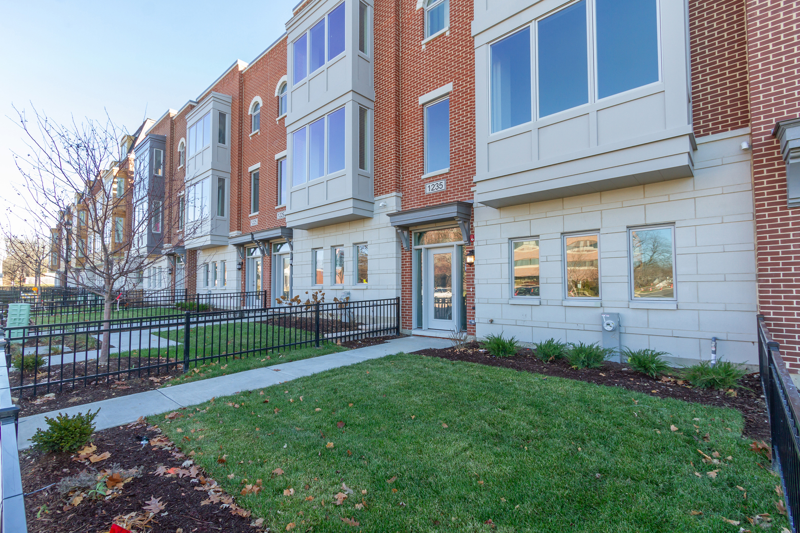 1235 Shermer Road Northbrook, IL 60062 - Photo 2 of 21 a view of a brick building next to a yard