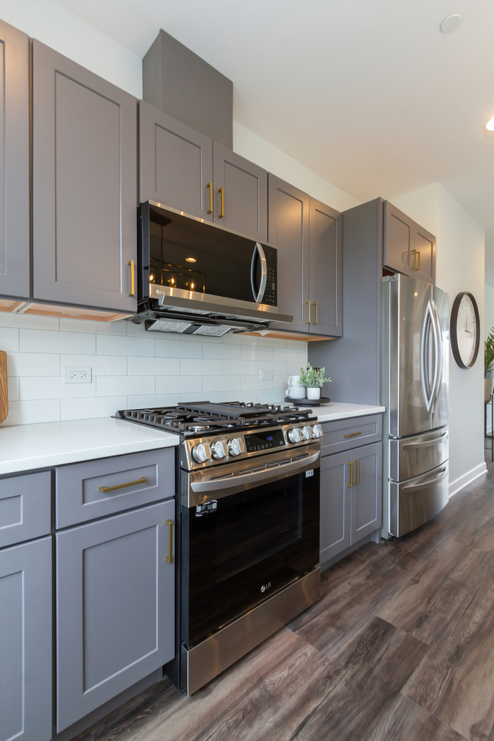 1235 Shermer Road Northbrook, IL 60062 - Photo 8 of 21 a kitchen with stainless steel appliances granite countertop a stove a refrigerator and a microwave