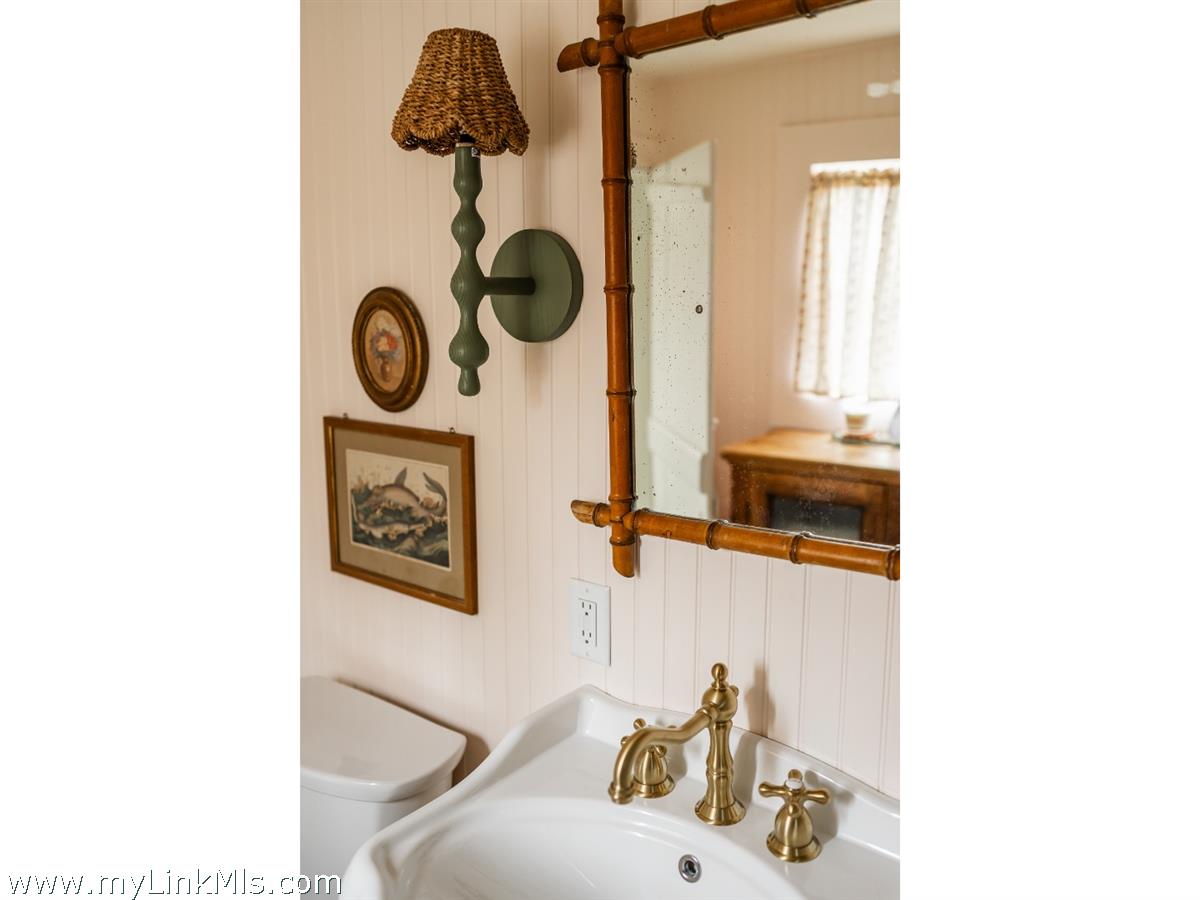 10 Centre Street Nantucket, MA 02554 - Photo 35 of 43 a bathroom with a sink and a mirror